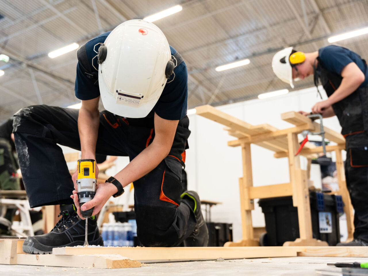 Two Competitors wearing hard hats drilling and measuring at the Estonian Exhibition Centre in Tallinn during the Young Master Skills Festival in May 2024.

&nbsp;
